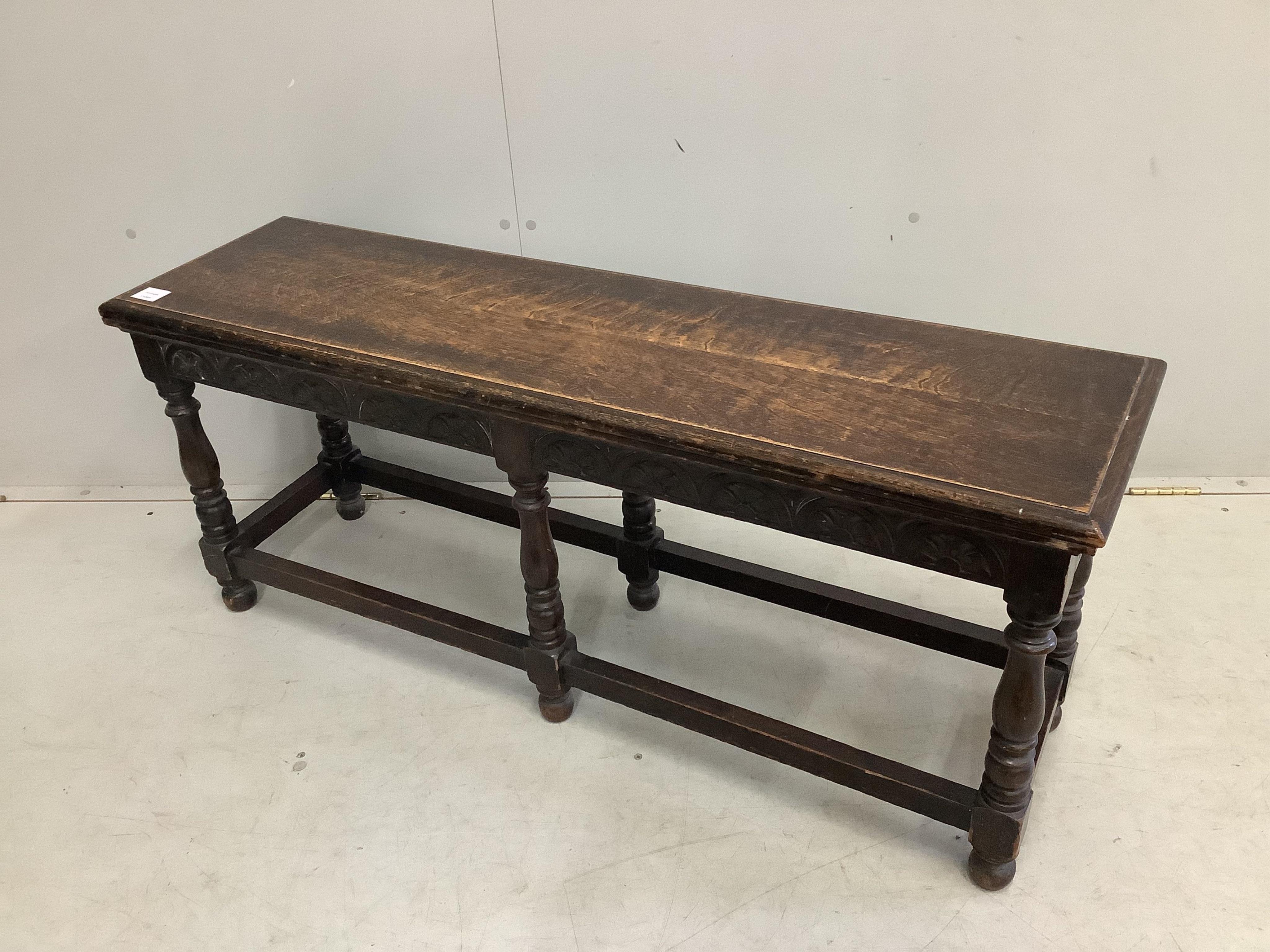 An early 20th century Jacobean Revival oak window seat, width 122cm, depth 34cm, height 51cm. Condition - fair